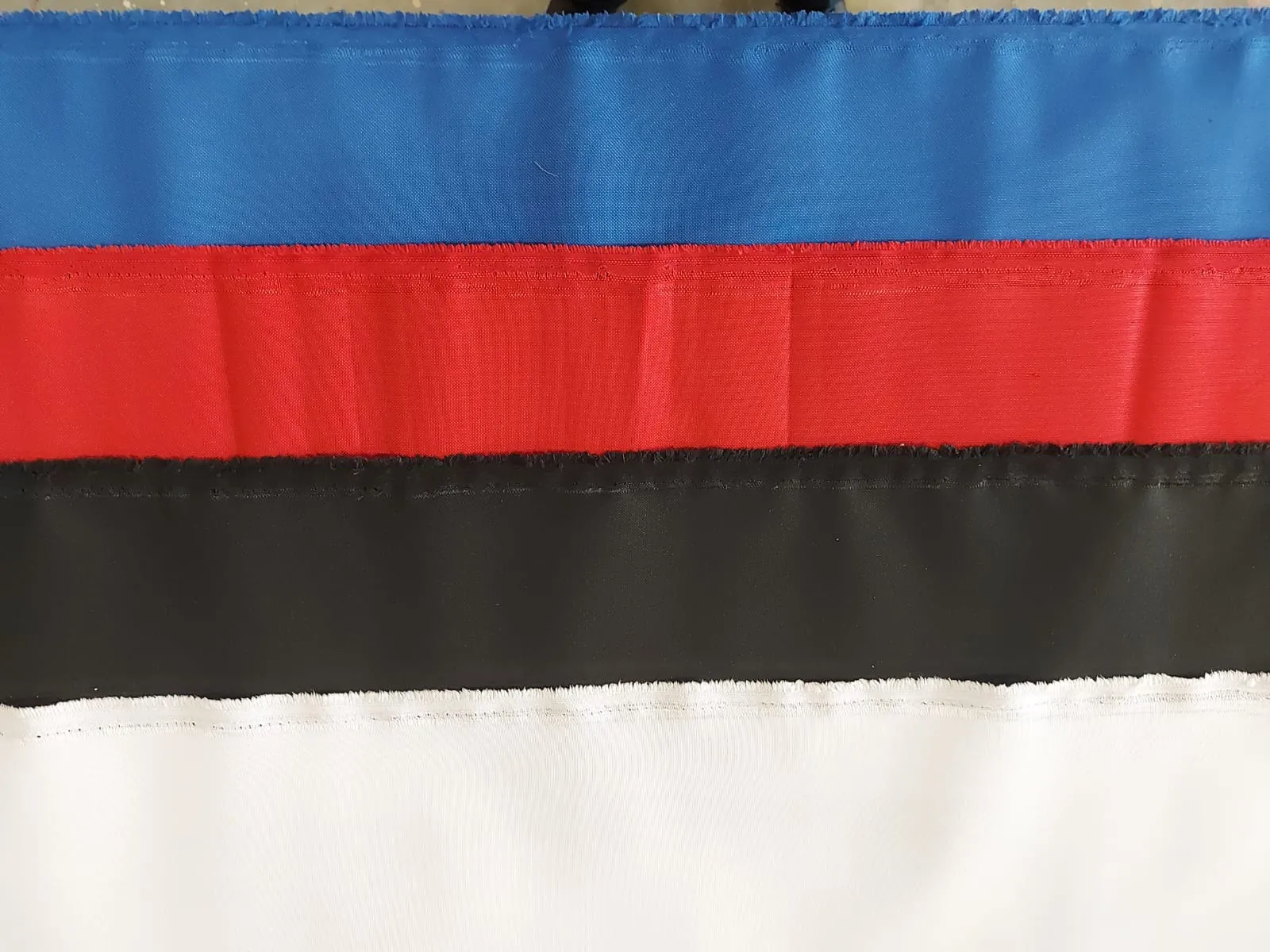 A picture showing polyvinyl covers in blue, red, black and white.